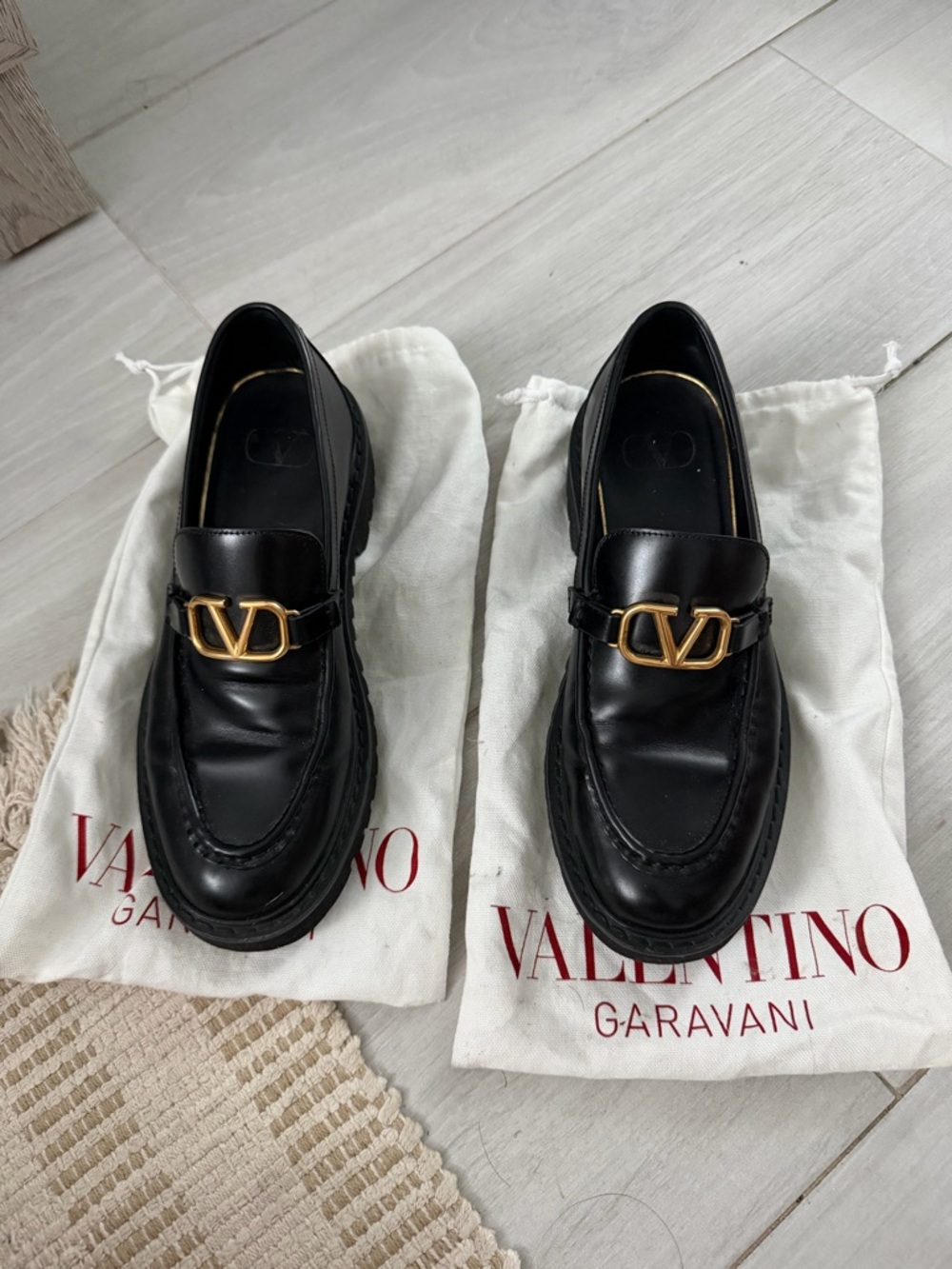 Valentino Garavani Black Leather Loafers with Gold V-Buckle